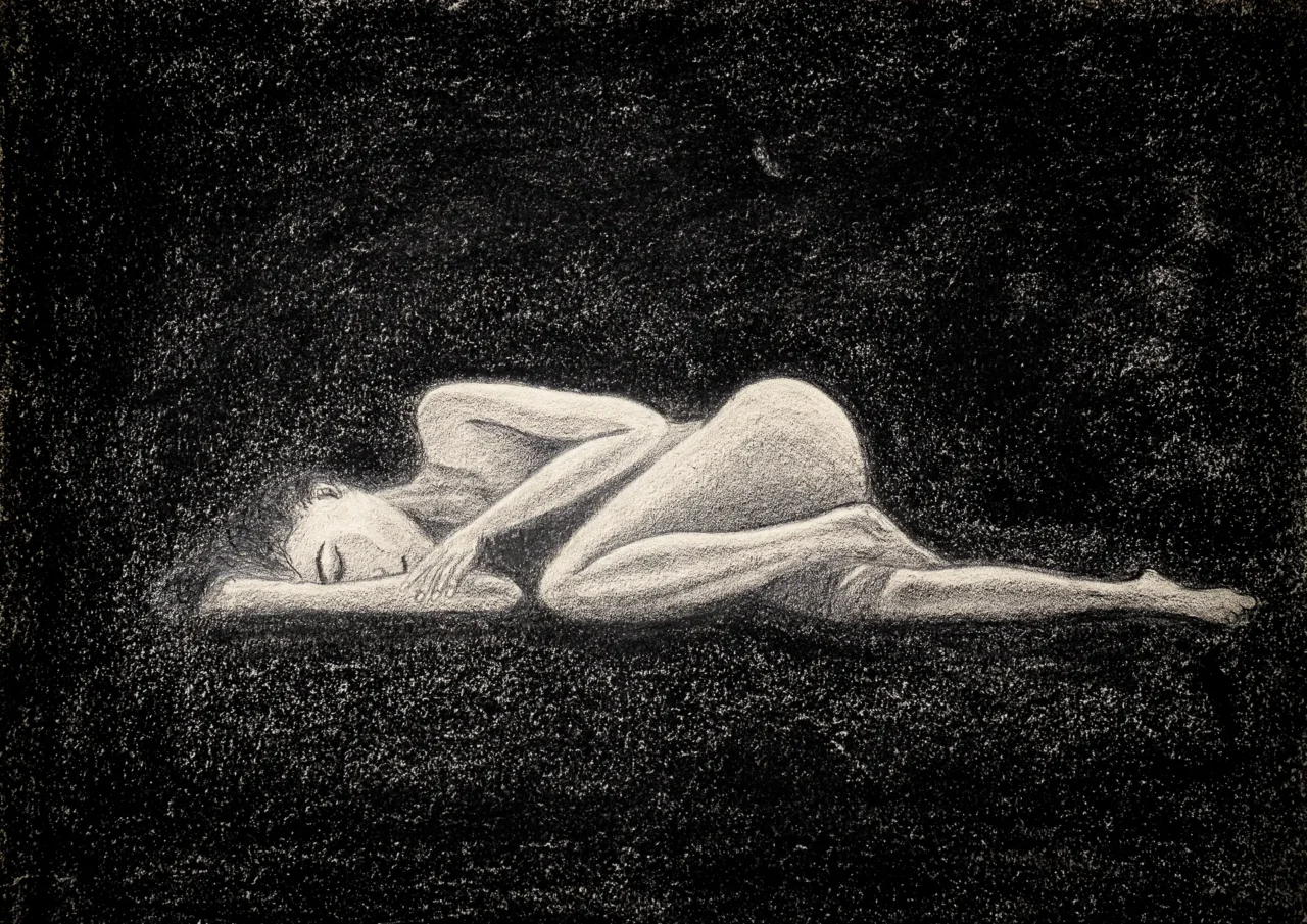 A light female figure lying on ground surrounded by darkness