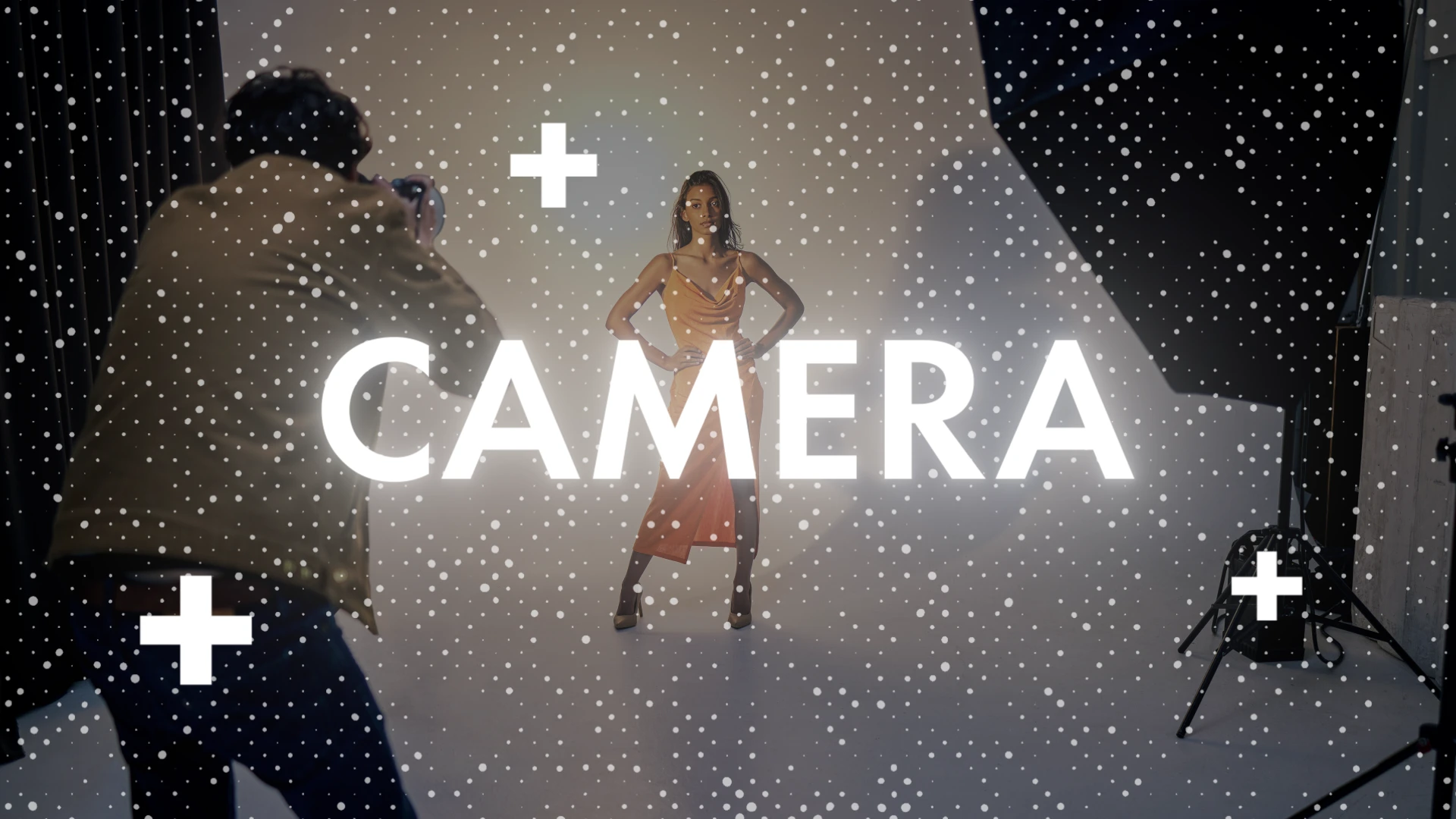 Text "Camera" and white halftone pattern on top of a scene of a woman posing in a photographic studio in orange dress